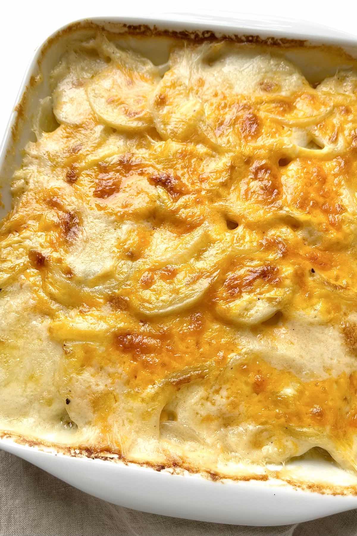 Mom's old fashioned scalloped potatoes in a white baking dish.