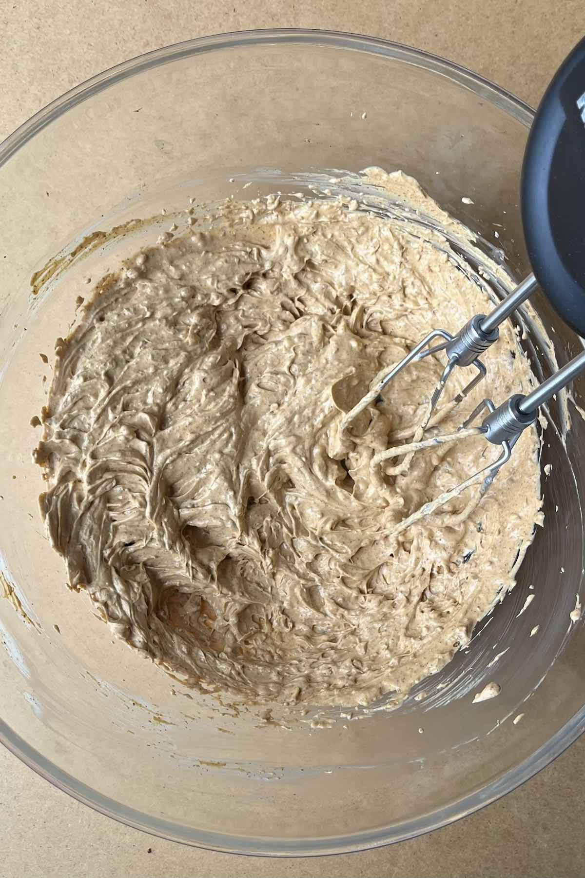 Sour cream, cream cheese, and taco seasoning mixed in a bowl.