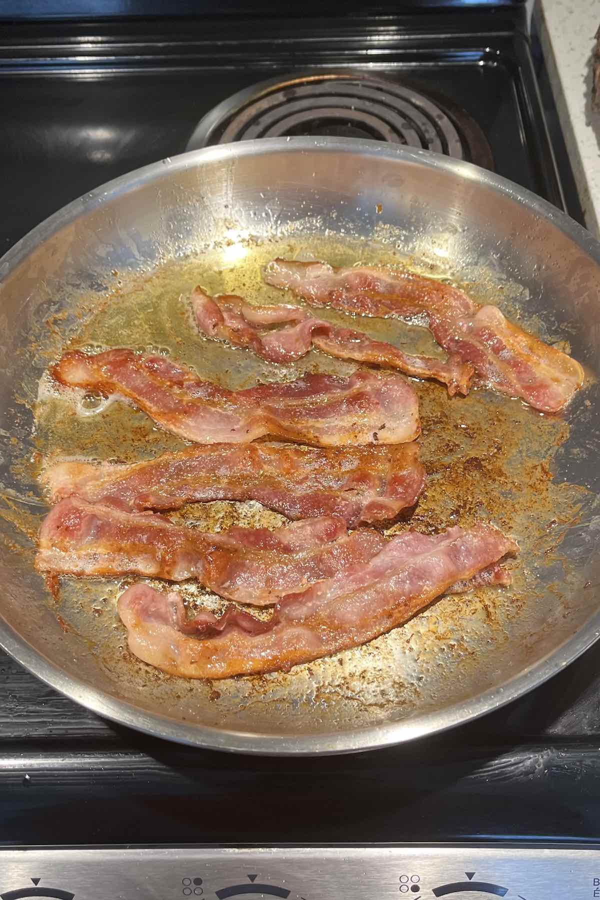 Bacon sliced in the pan cooked.