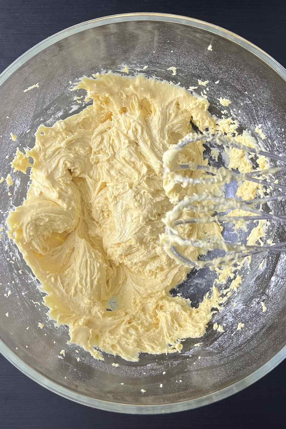 Lemon cake mix, eggs, vegetable oil, and lemon zest mixed in a bowl.