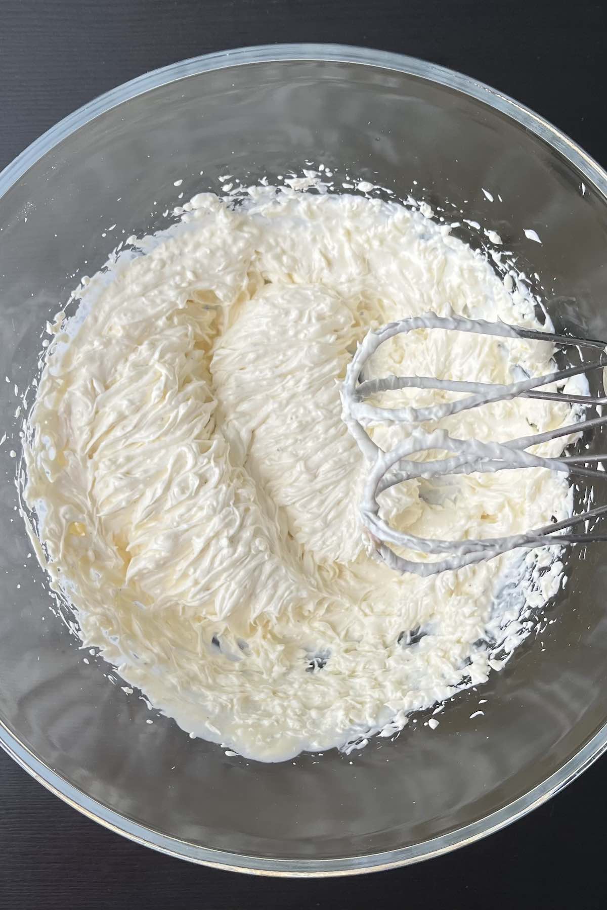 Sour cream, cream cheese, mayo, salt, pepper, and garlic powder mixed in a bowl.
