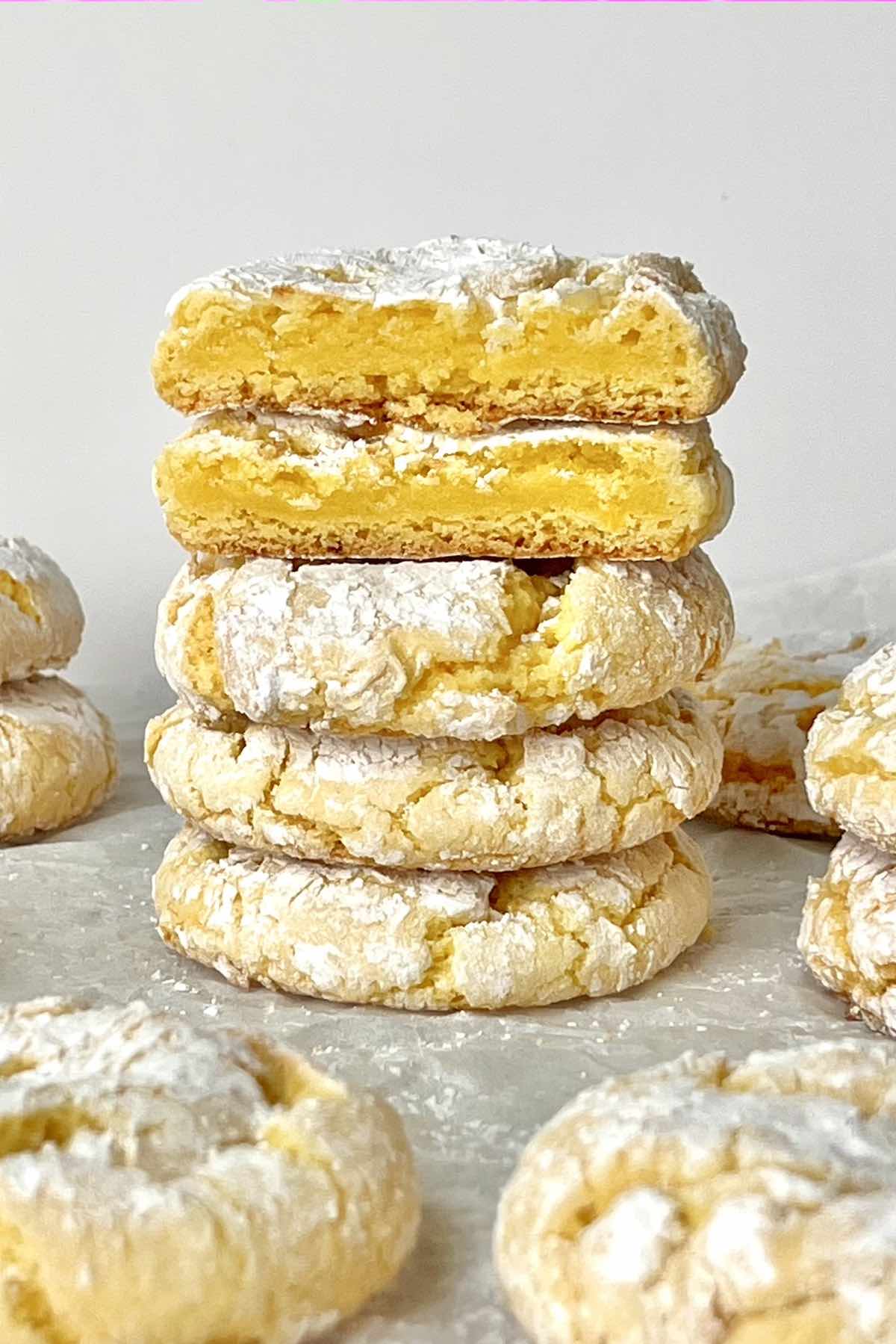 Stack of five lemon crinkle cookies with cake mix.