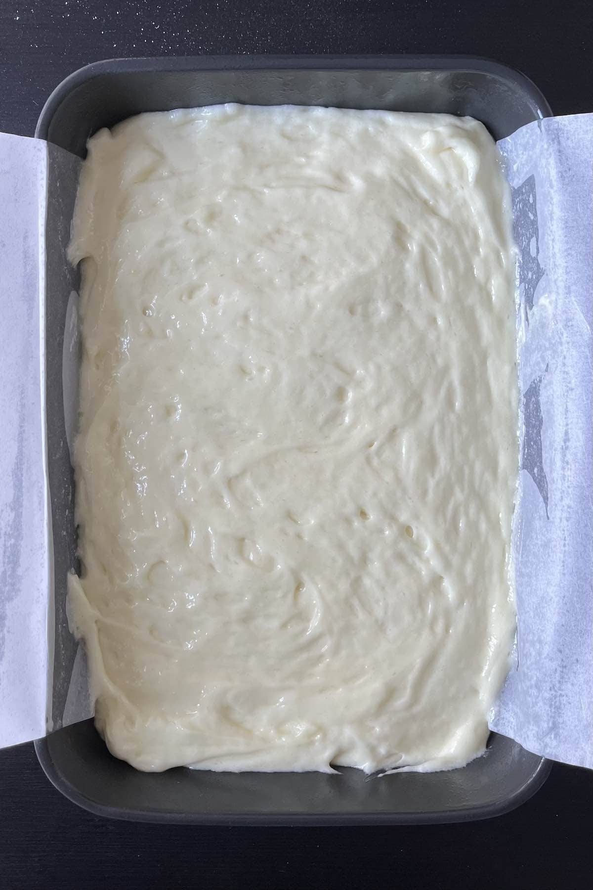 Lemon bar batter in a 9x13 baking dish.