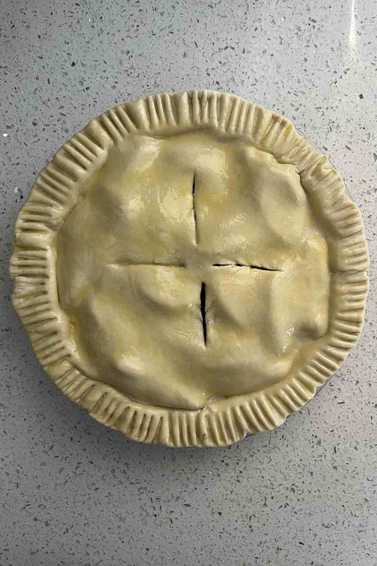 Egg wash spread over the top of the pie.