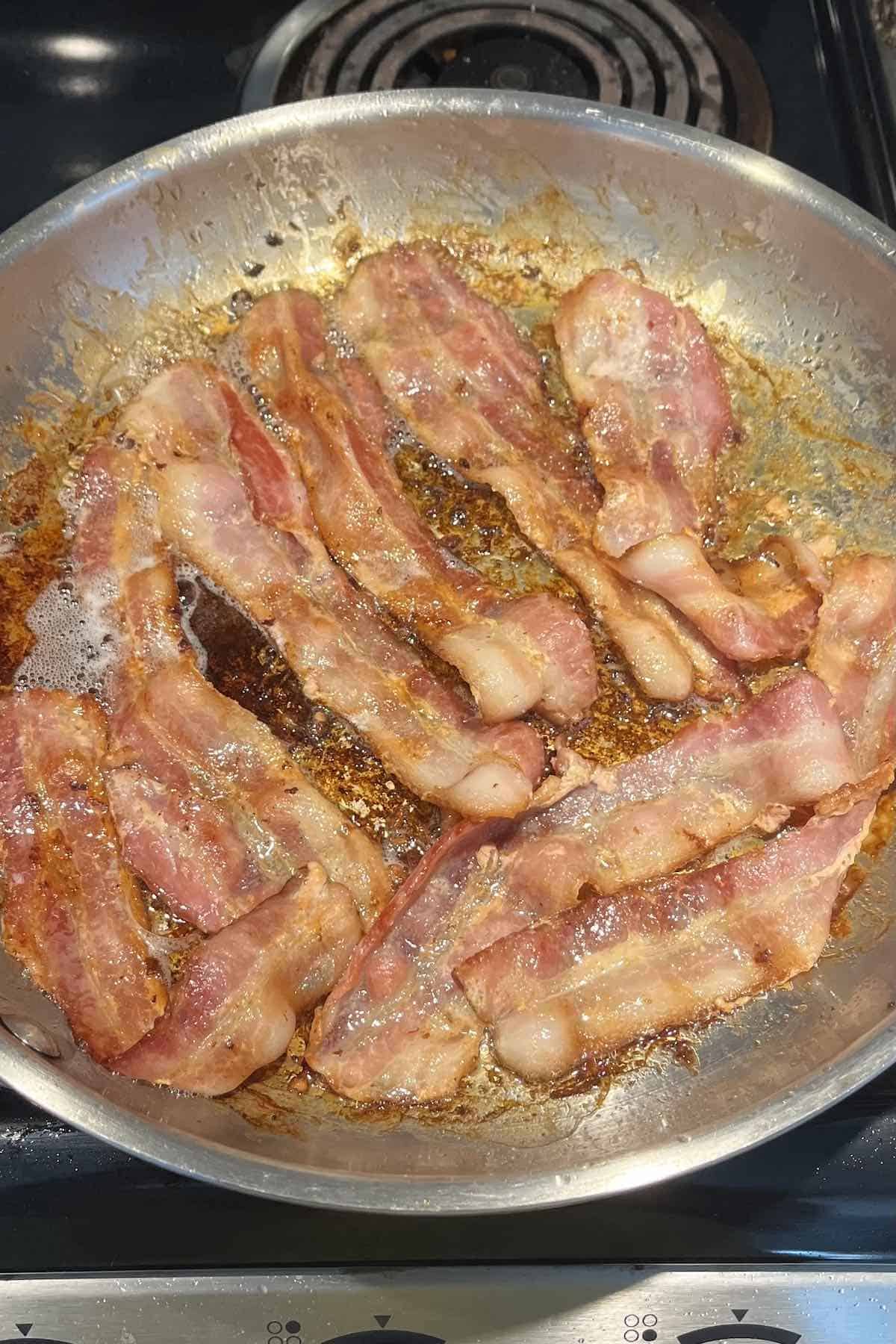 Bacon frying in a pan.