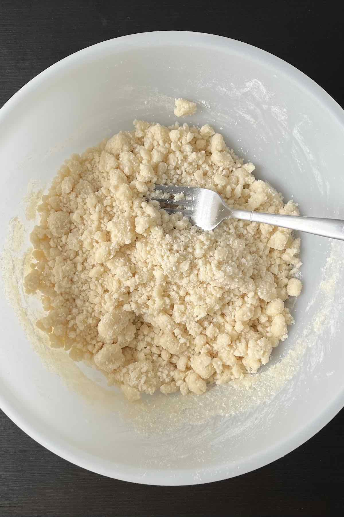 Cake mix and melted butter mixed together in a bowl.