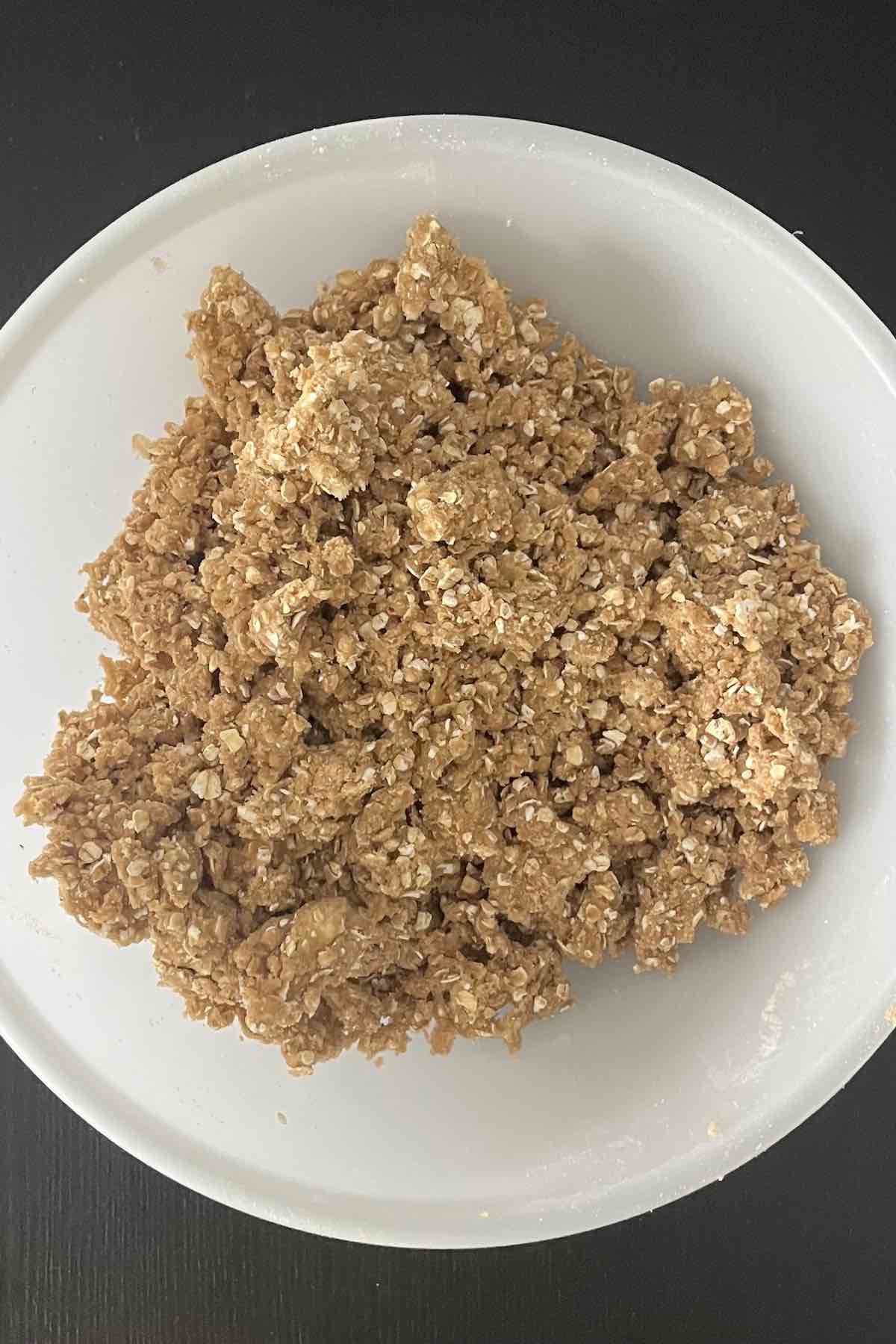 Topping ingredients mixed into a crumbly texture in a bowl.