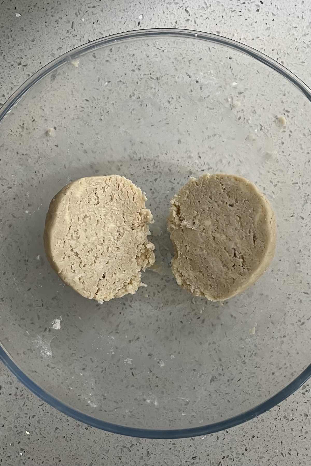 Pie dough ball sliced in half.
