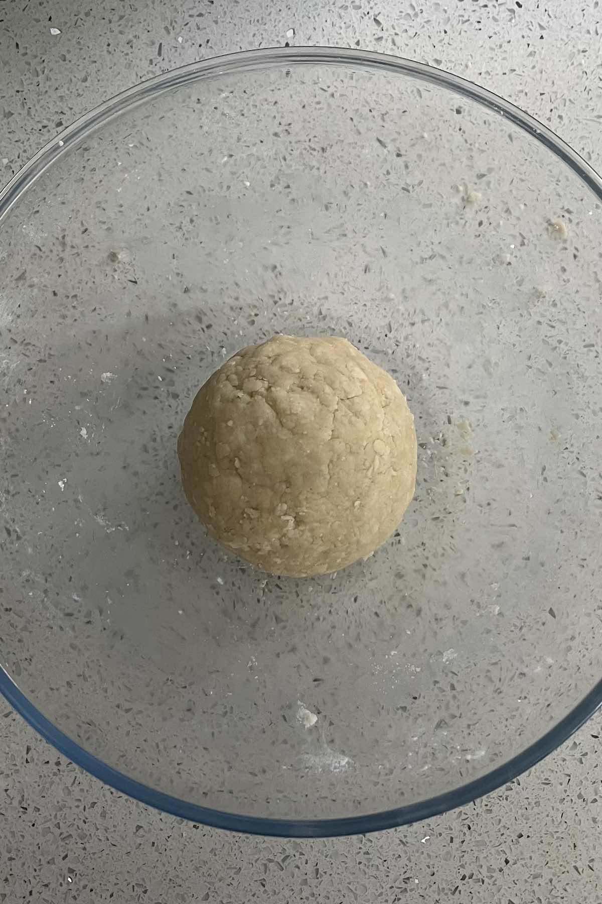 Pie dough formed into a ball shape.