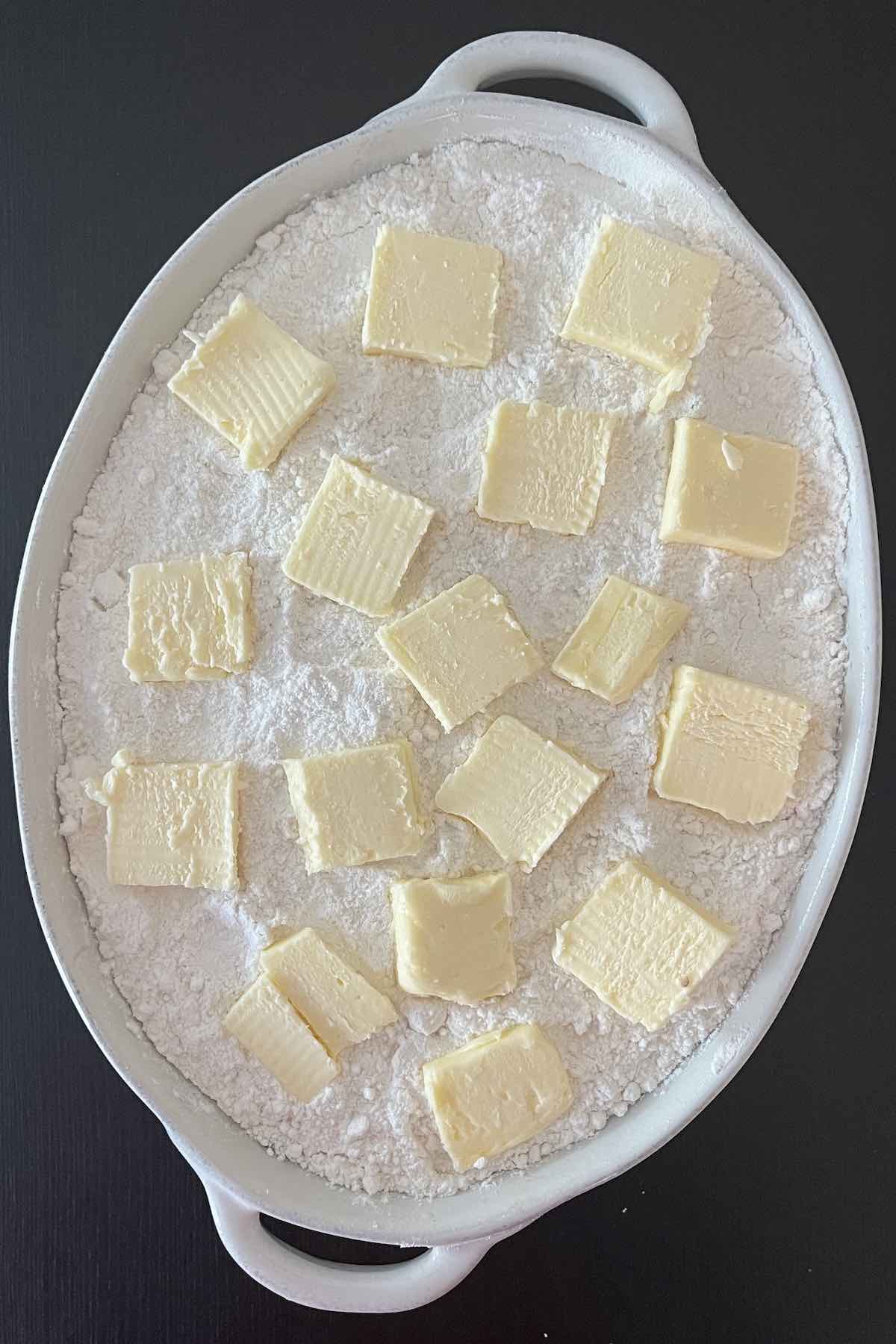 Butter slices distributed on the cake mix.
