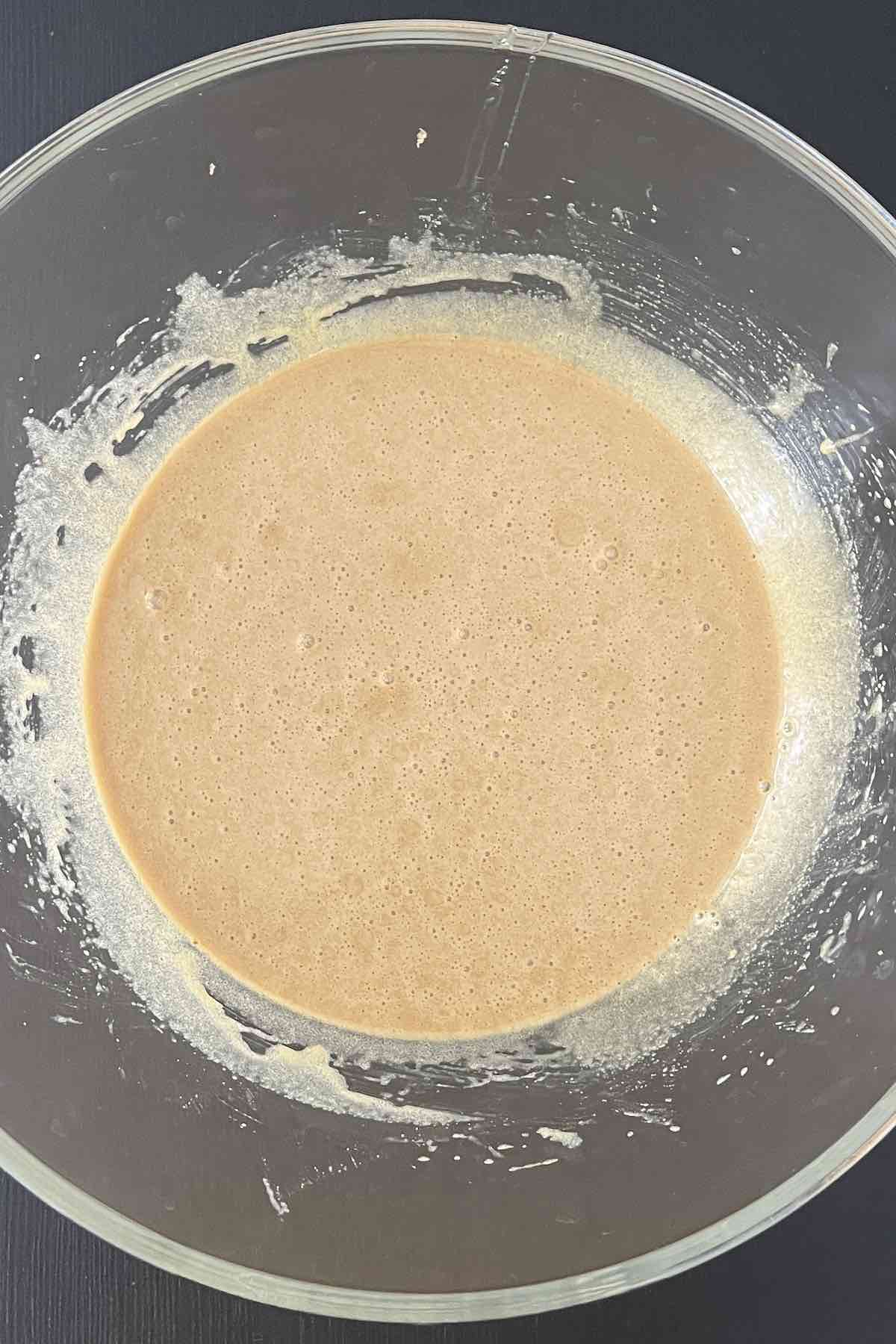 Butter, brown sugar, corn syrup, and eggs mixed in a bowl.