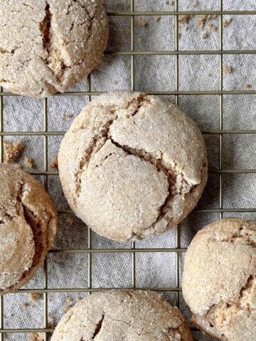 Spice cake mix cookies scattered on a cooling rack.