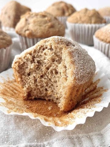 Apple spice muffin with a bite taken from it.