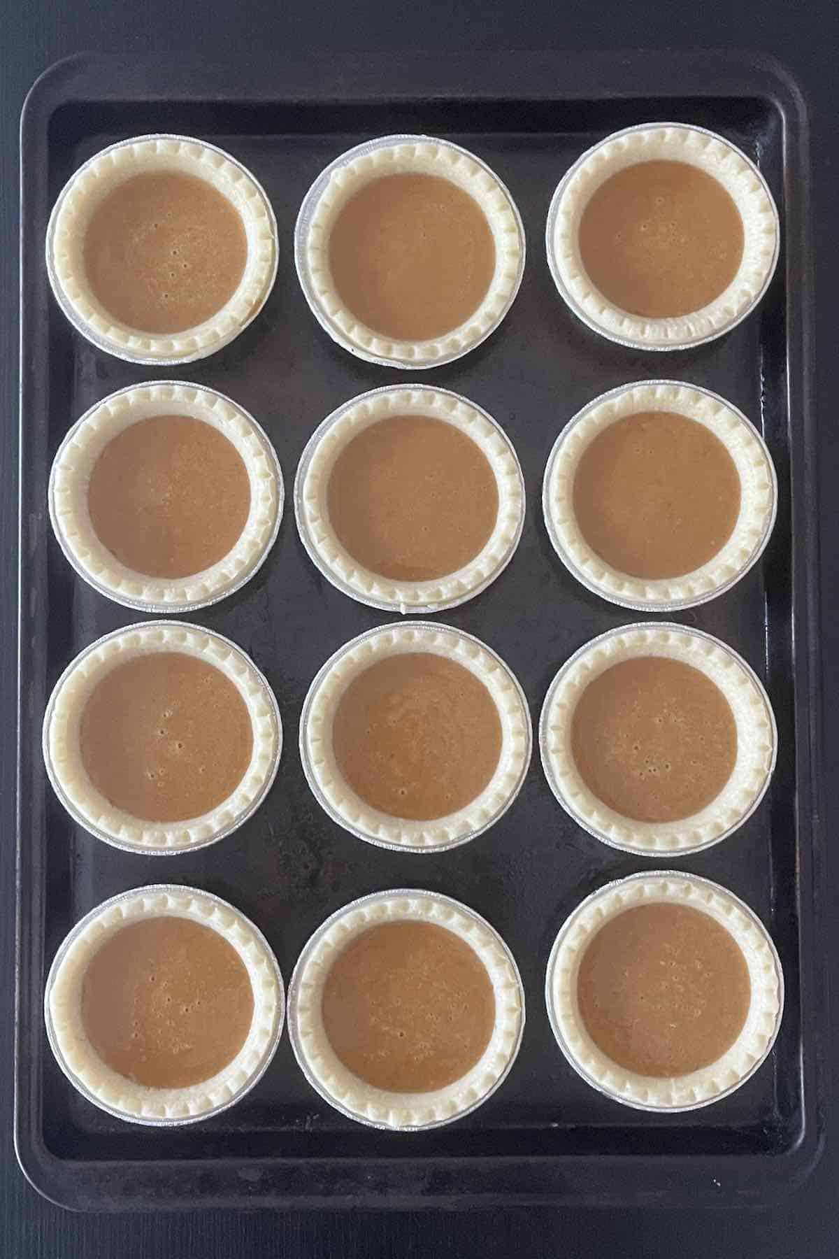 Tart shells filled with pumpkin filling.