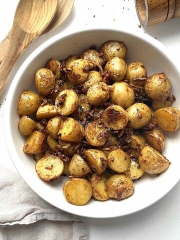 Roasted potatoes with onion soup mix in a white serving bowl.