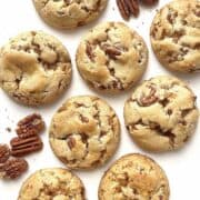 Butter pecan cookies scattered on a table.