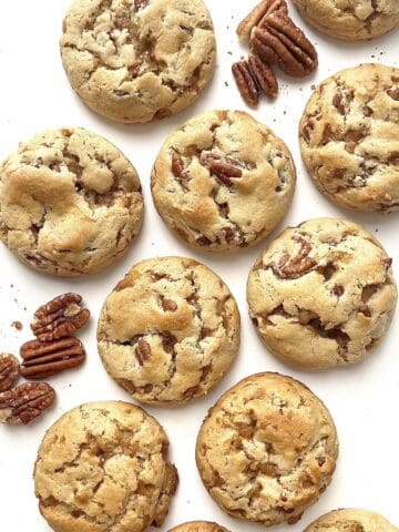 Butter pecan cookies scattered on a table.