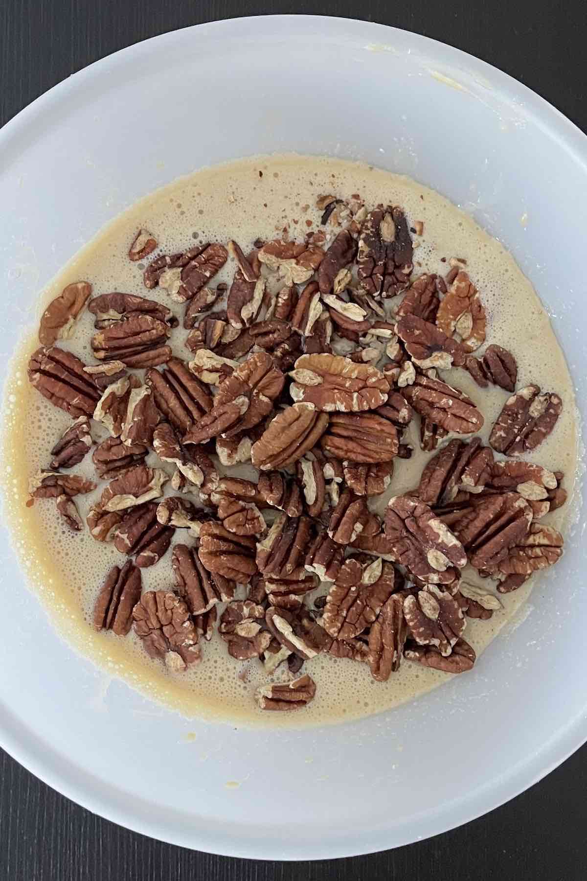 Pecans added to the bowl of ingredients.