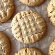 Cake mix peanut butter cookies scattered on a piece of parchment paper.