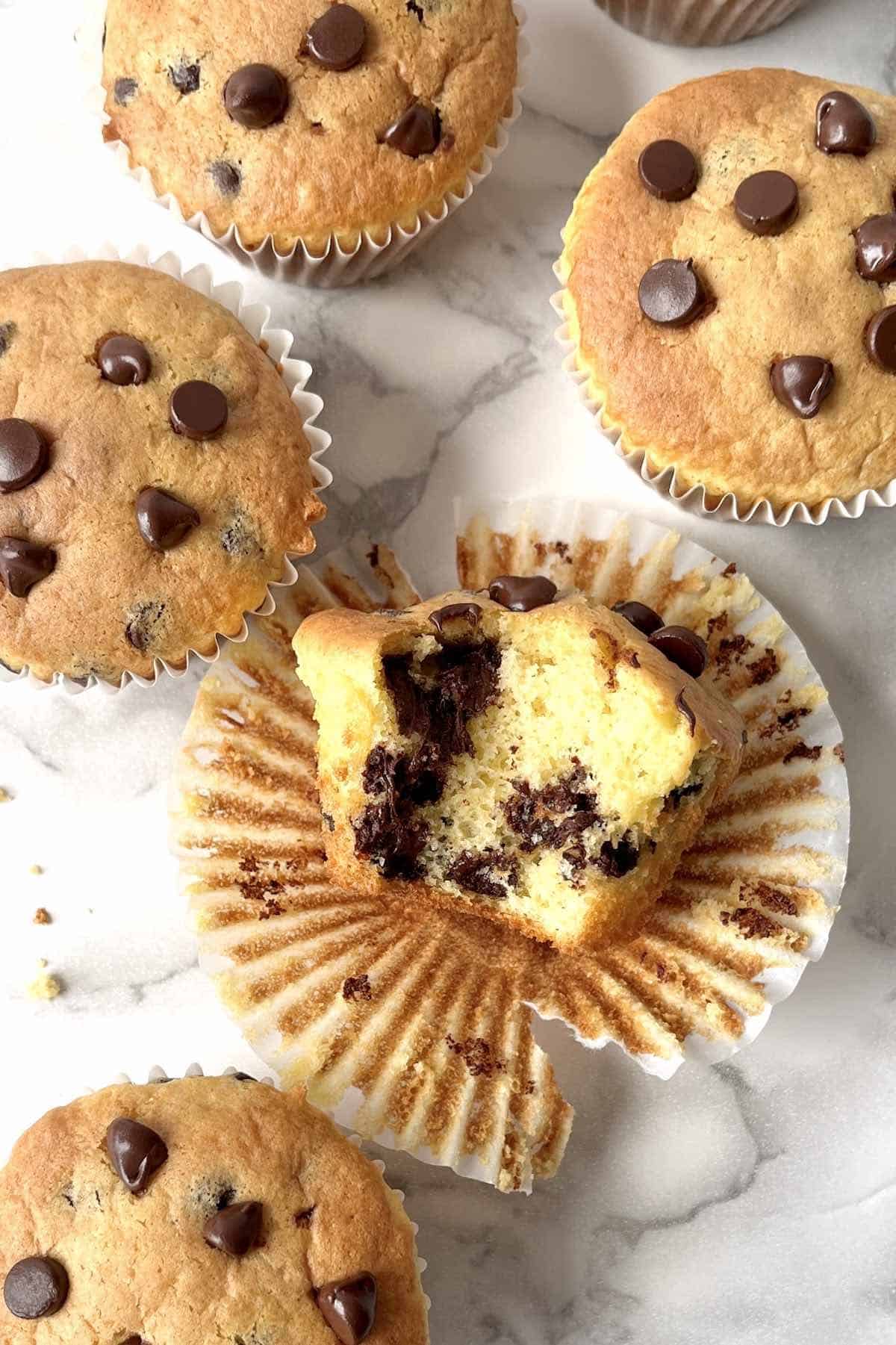 Chocolate chip cake mix muffin with a bite taken from it.