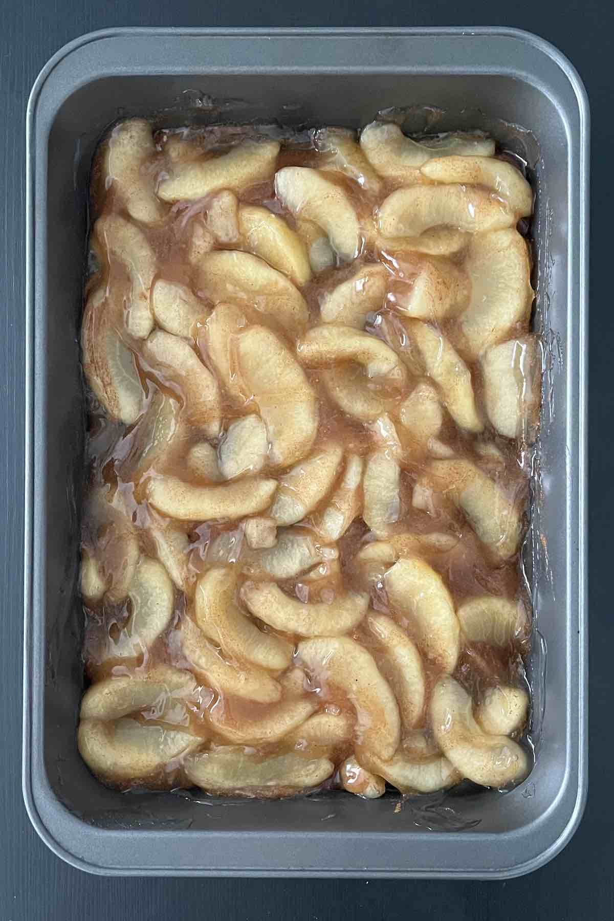 Apple pie filling, cinnamon, and nutmeg combined in a baking dish.
