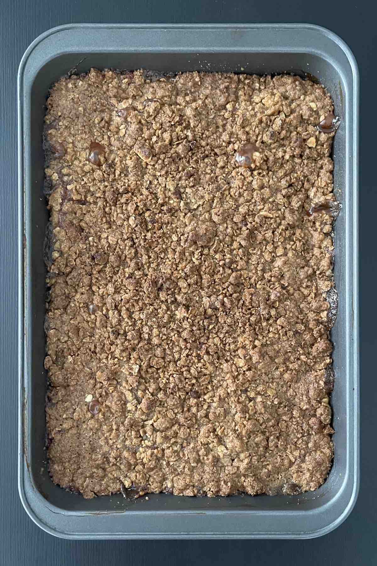 Baked granola apple crisp in a baking dish.
