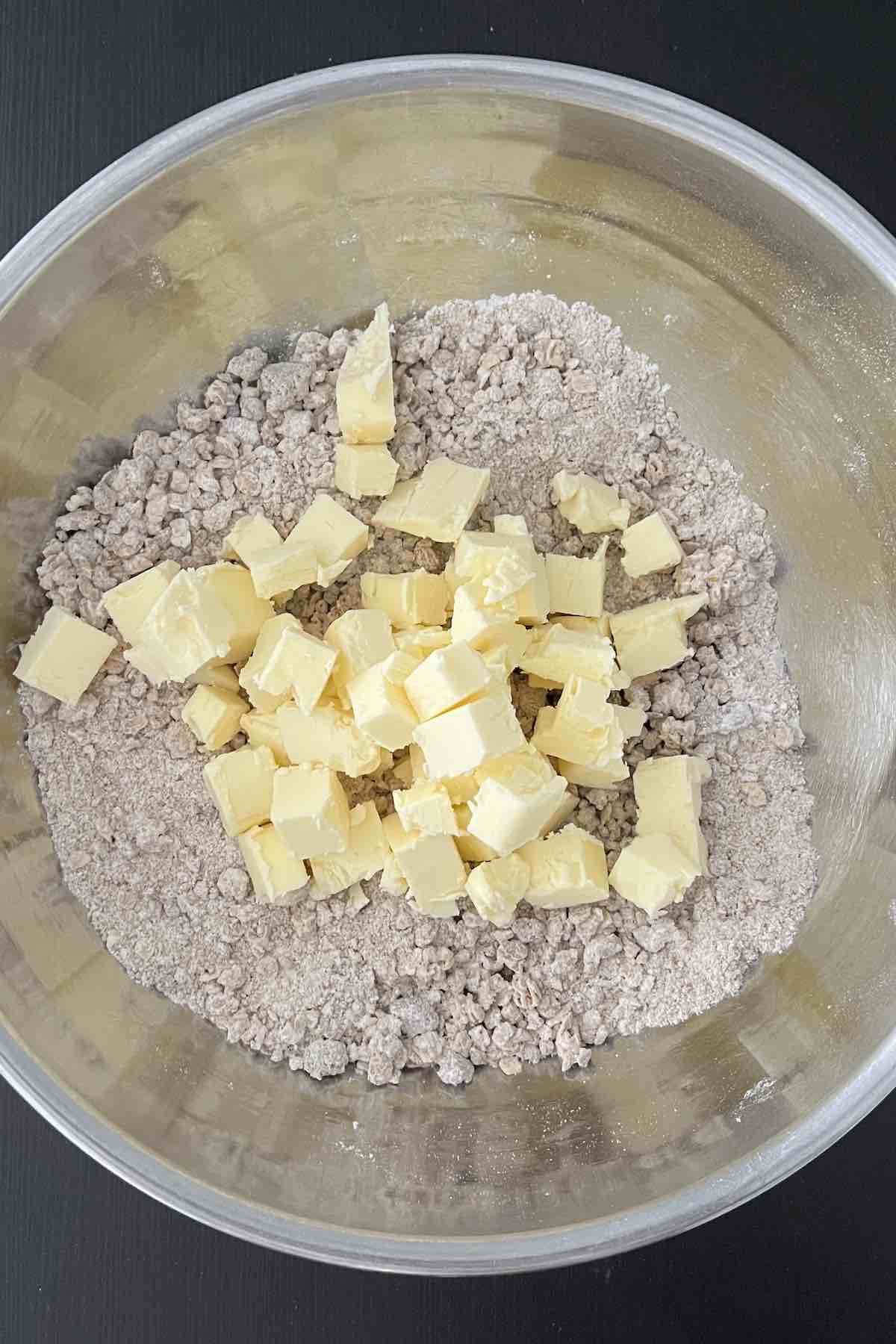 Granola, brown sugar, flour, cinnamon, salt, and butter in a bowl.