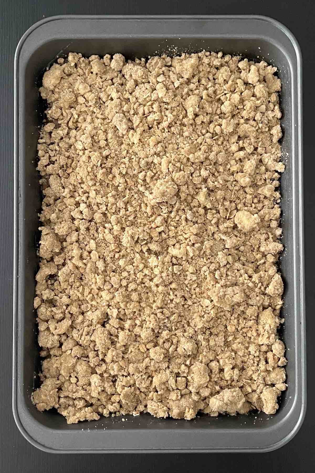 Unbaked apple crisp in a baking dish.