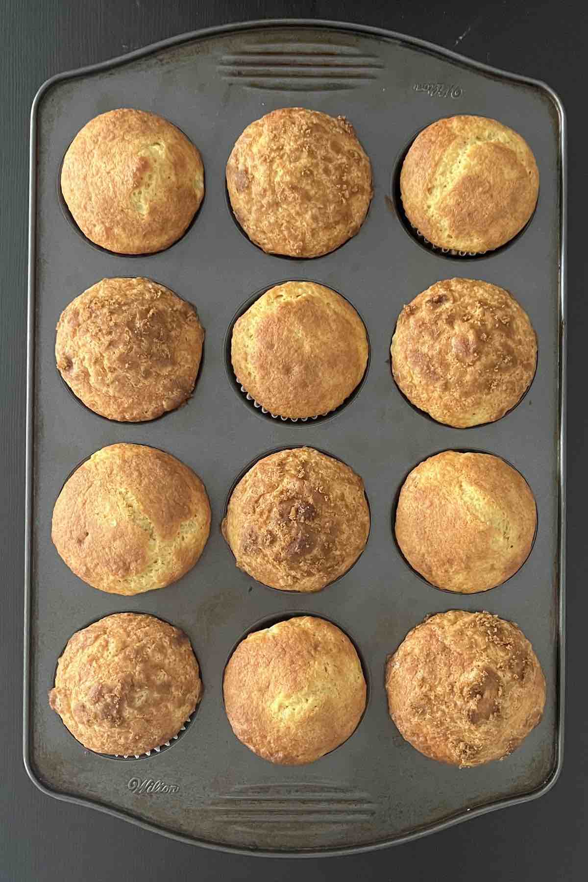 Baked banana muffins in a muffin pan.