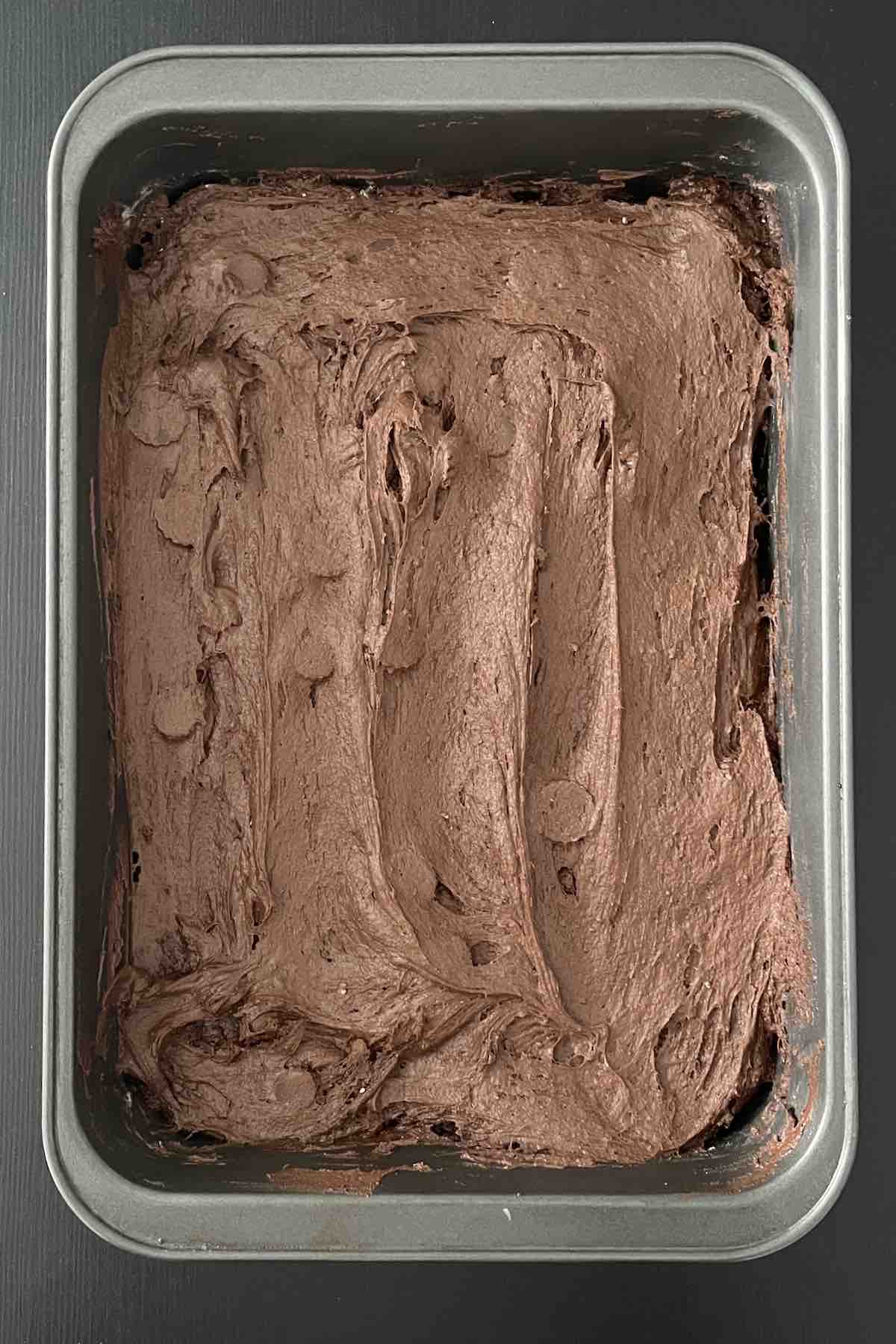 Batter and peanut butter cups combined in baking dish.