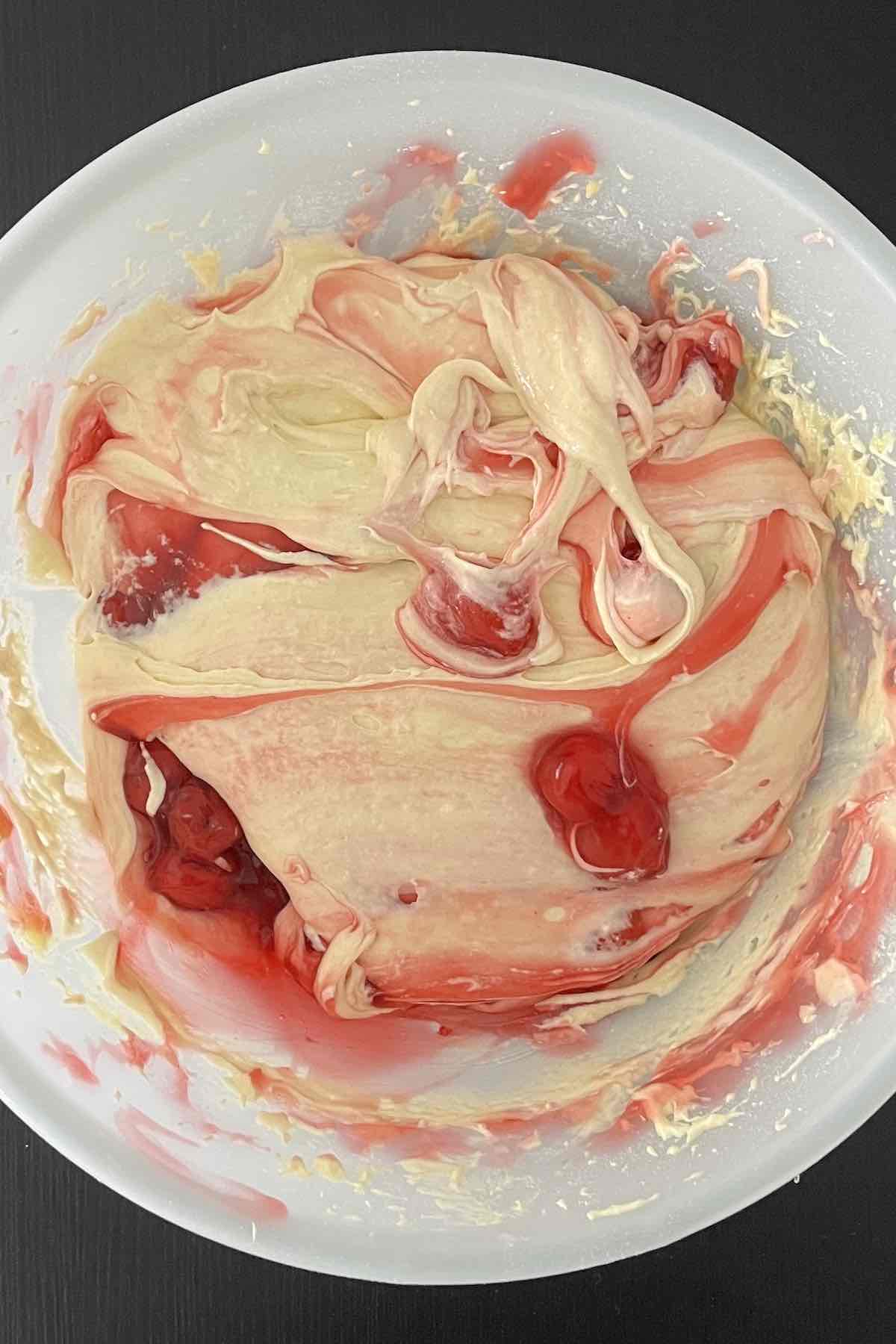 Cherry pie filling folded into the bowl of cake mix and eggs.