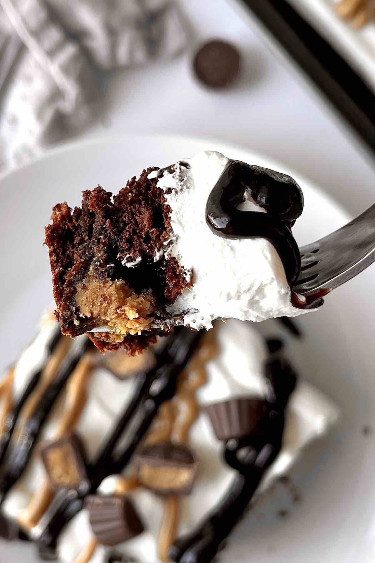 Fork with chocolate peanut butter cup dump cake on it.