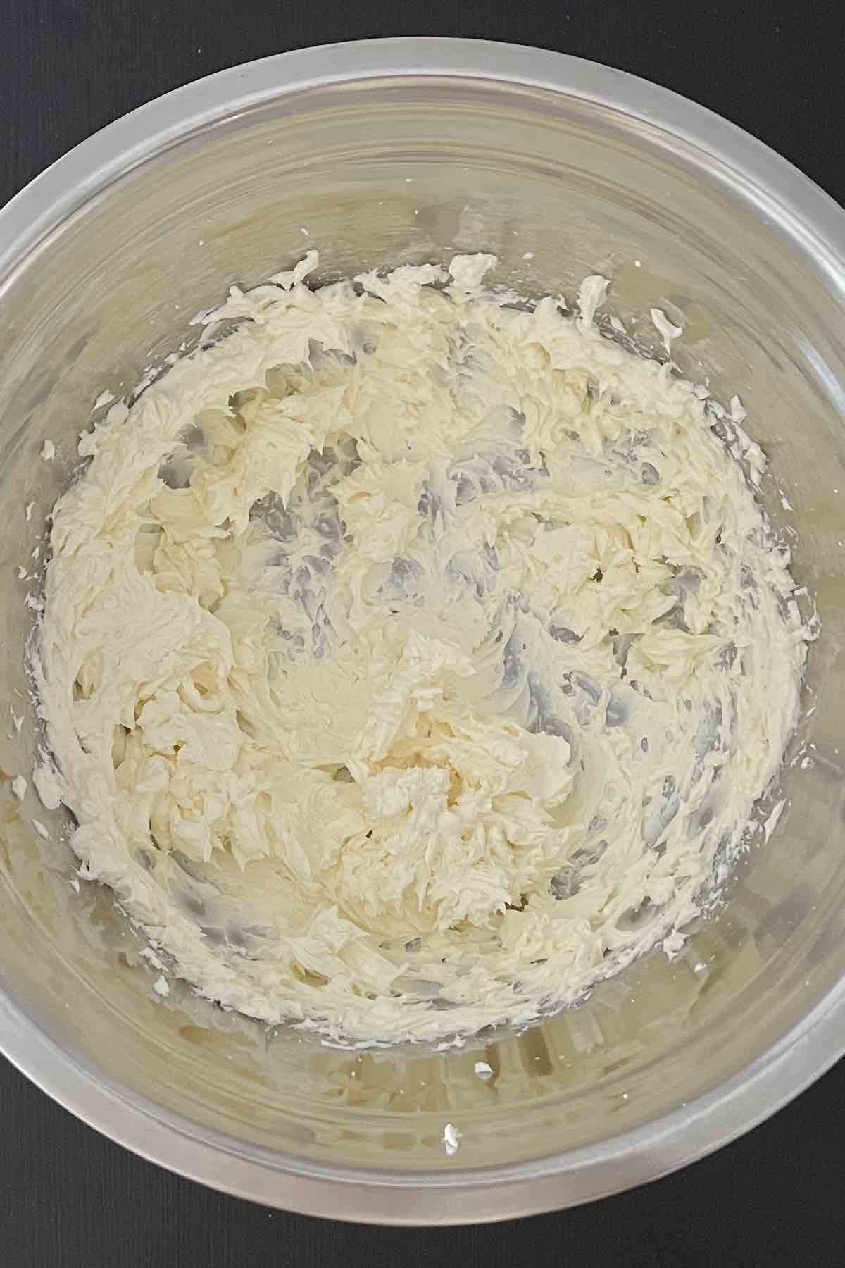 Cream cheese whipped in a bowl.
