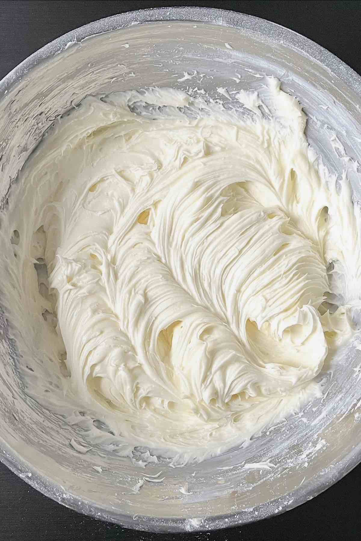 Cream cheese frosting in a bowl.