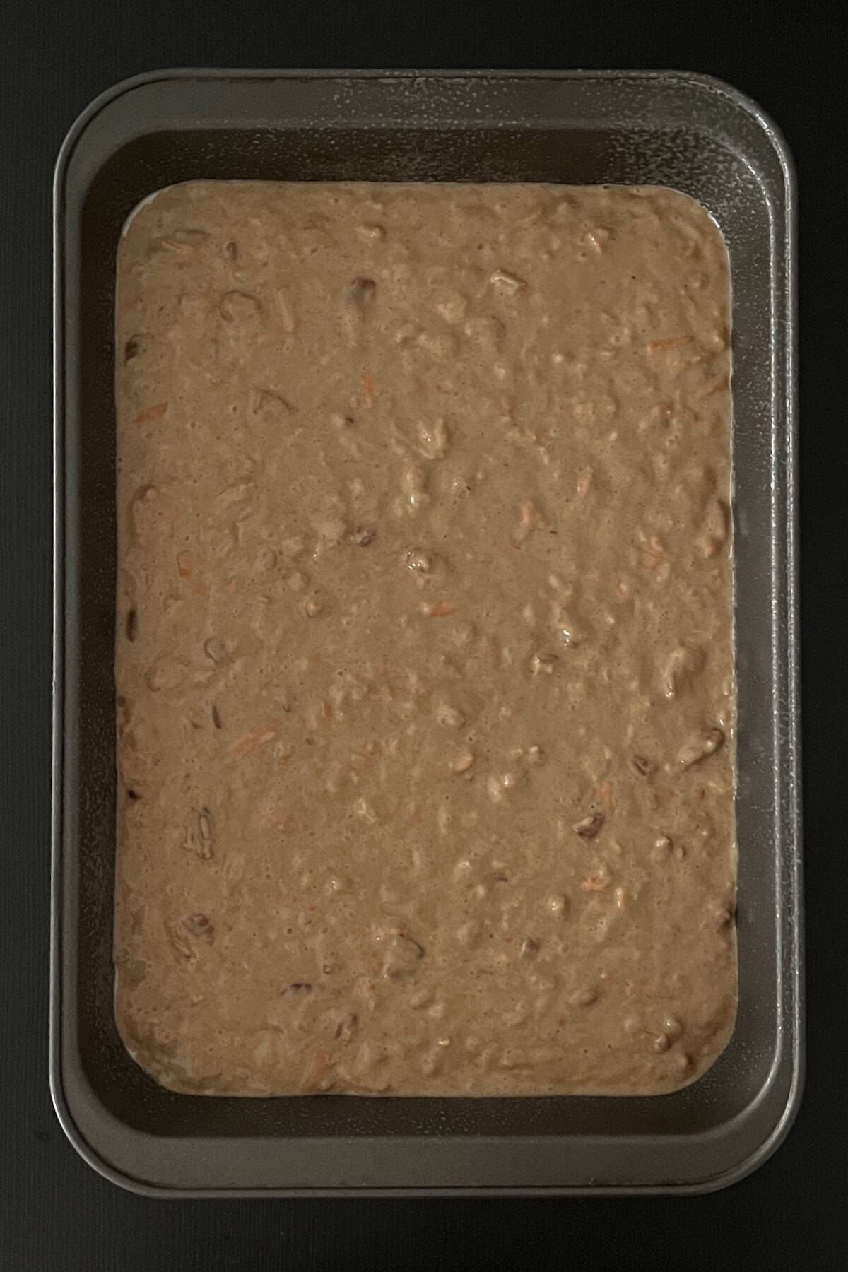 Cake batter poured into the prepared baking dish.