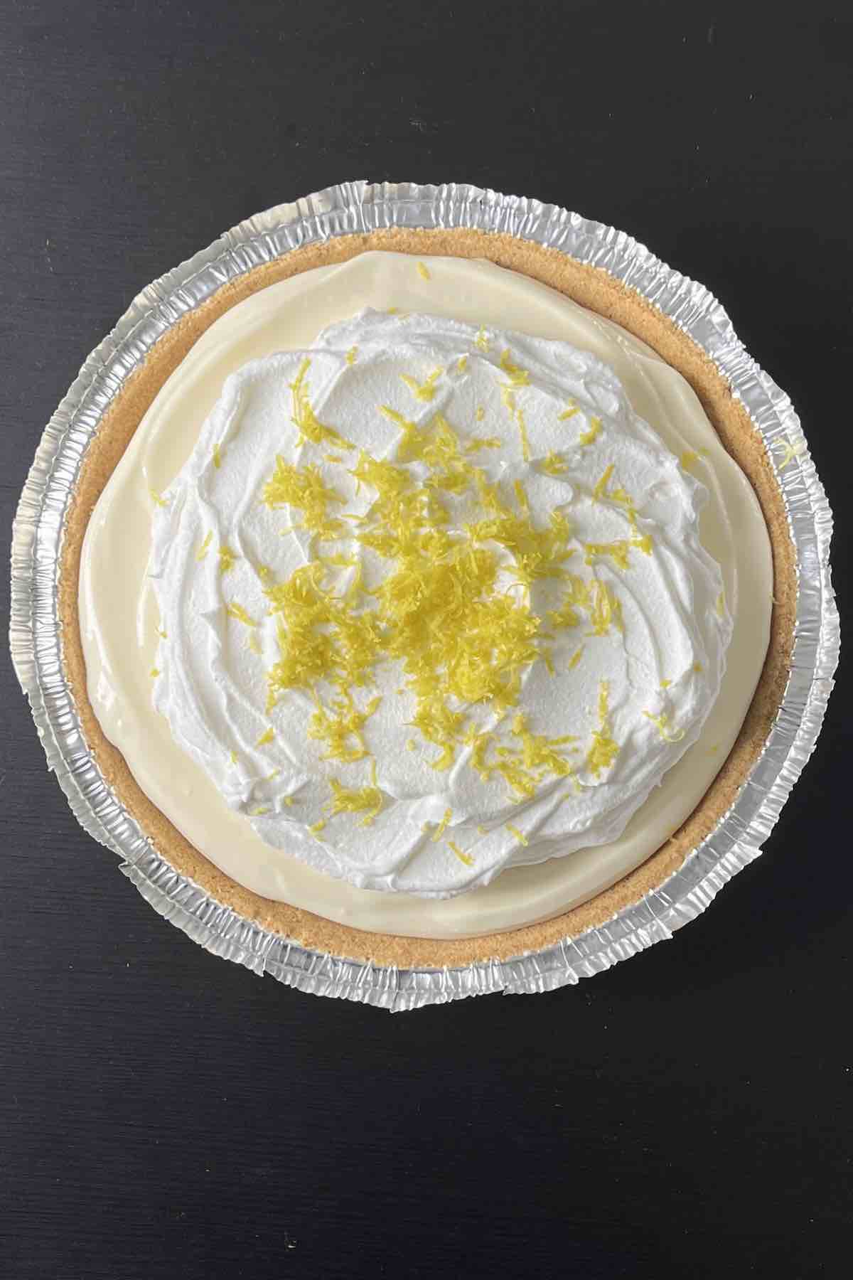 Pie topped with Cool Whip and lemon zest.