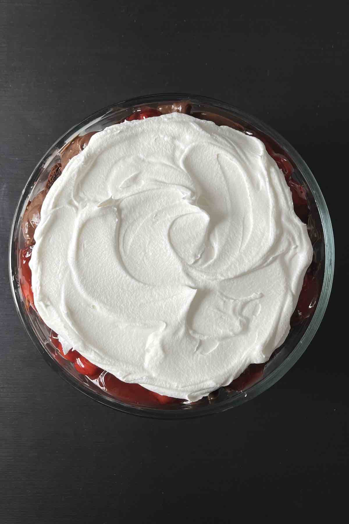Second layer of cake pieces, chocolate pudding, cherry pie filling, and Cool Whip in the trifle dish.
