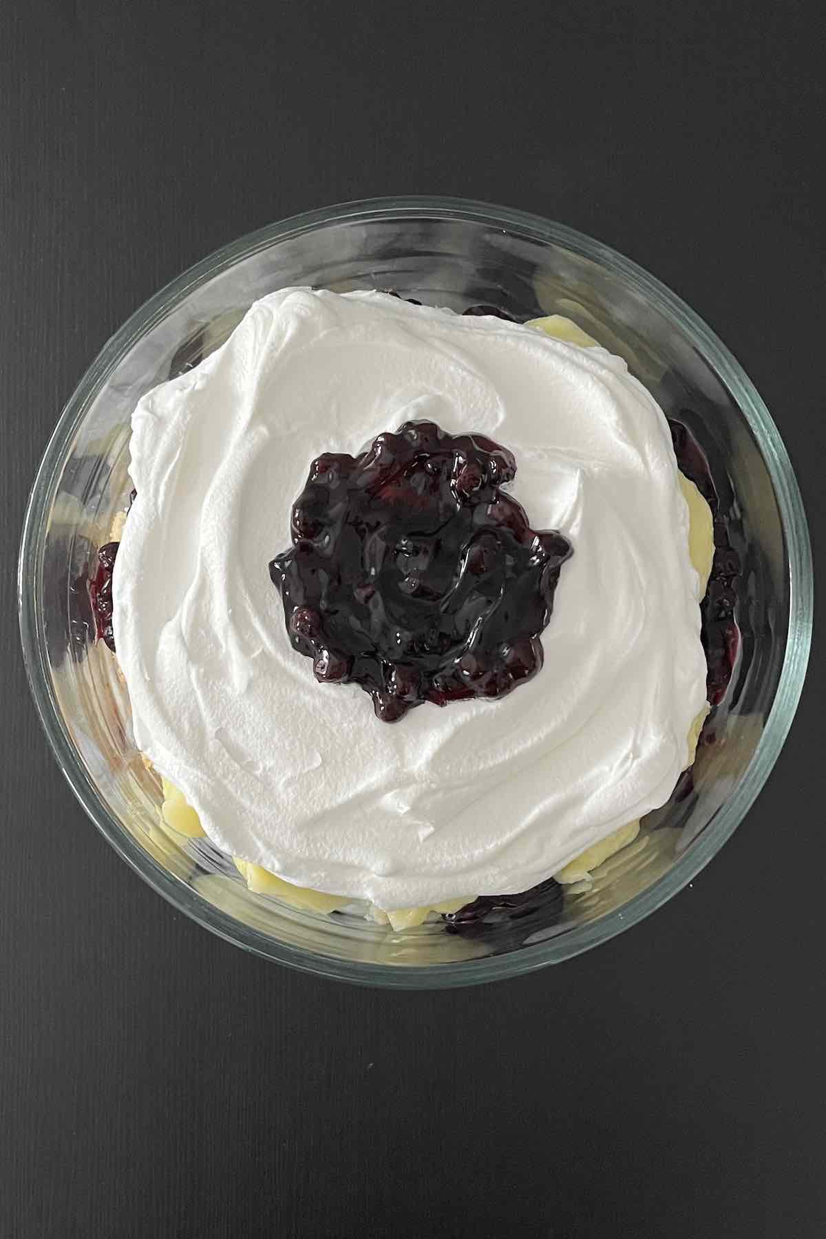 Second layer of cake, blueberry filling, vanilla pudding and cool whip in a trifle dish.