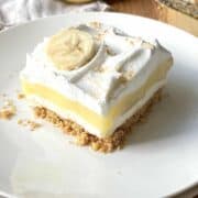 Slice of banana cream delight on a white plate.