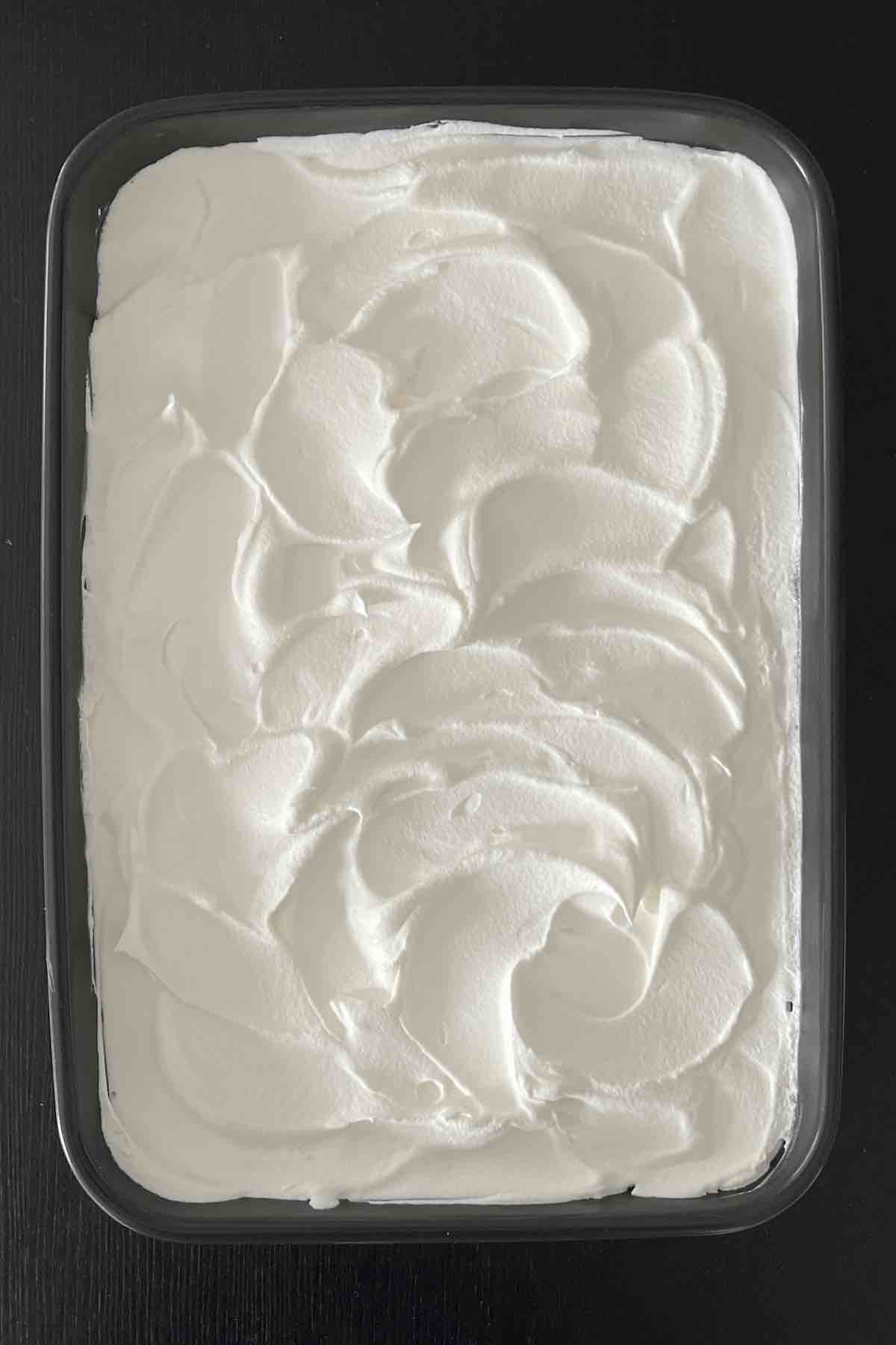 Cool whip layer spread over pudding.