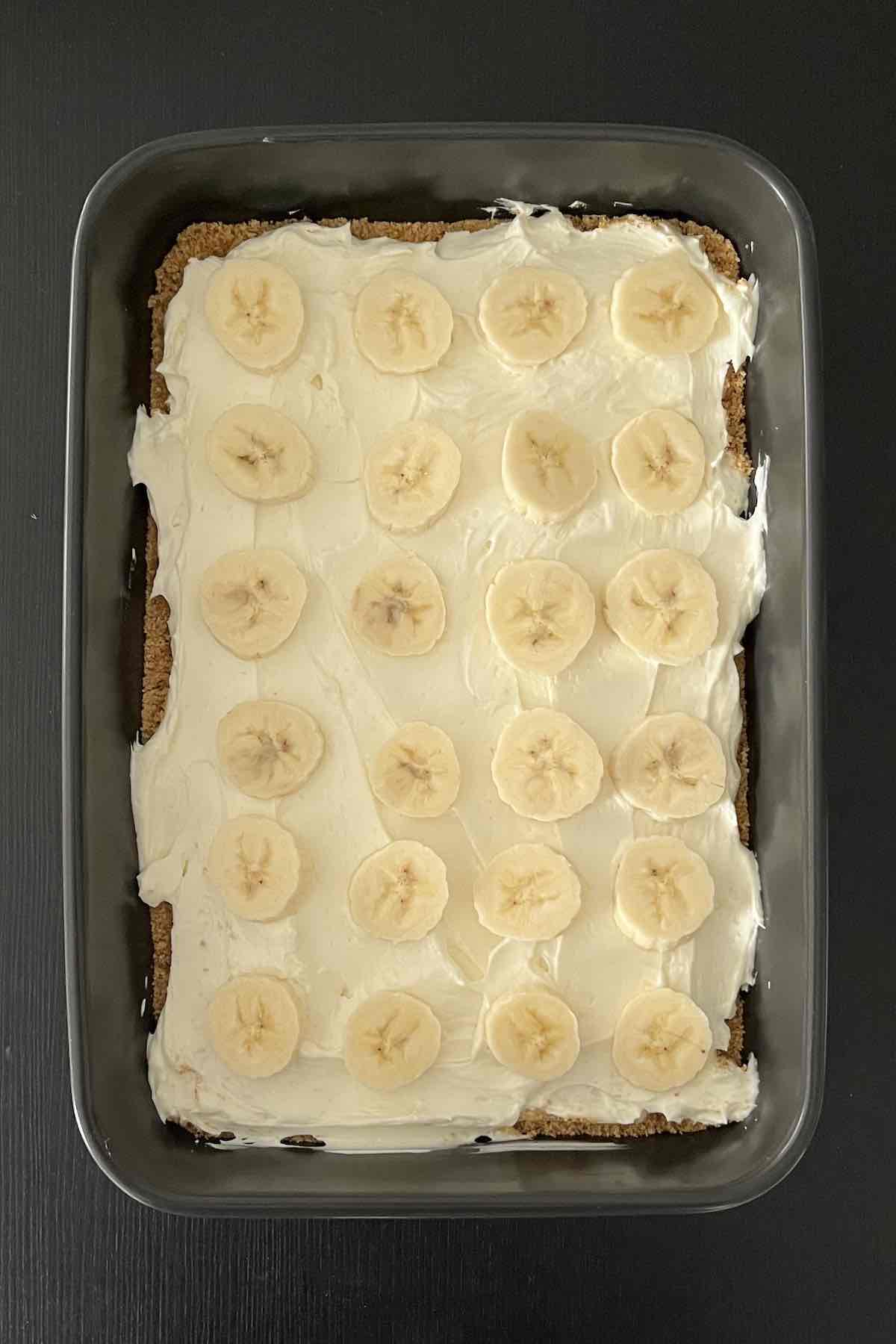 Cream cheese layer with bananas on graham cracker crust.