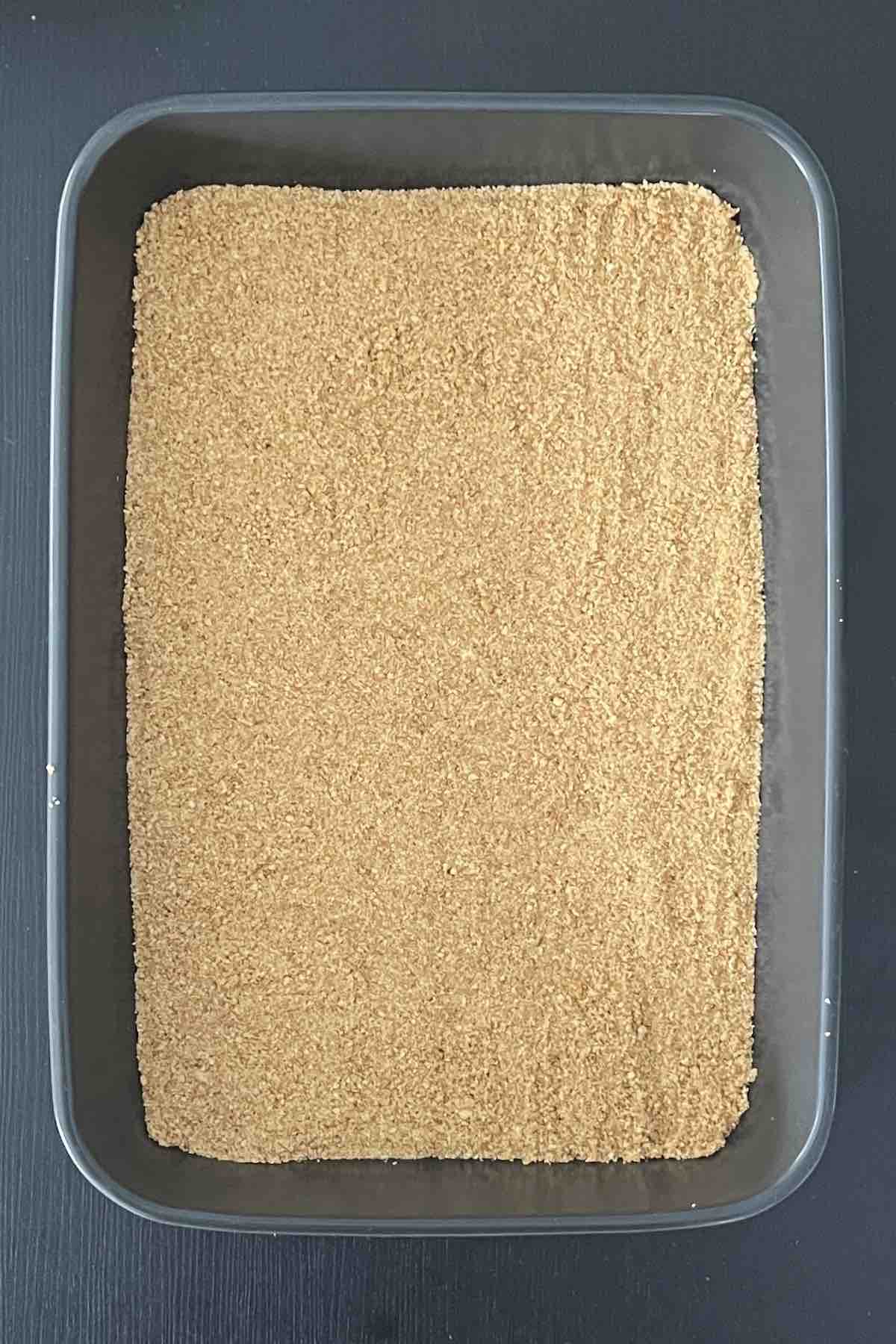 Graham cracker crust in baking dish.