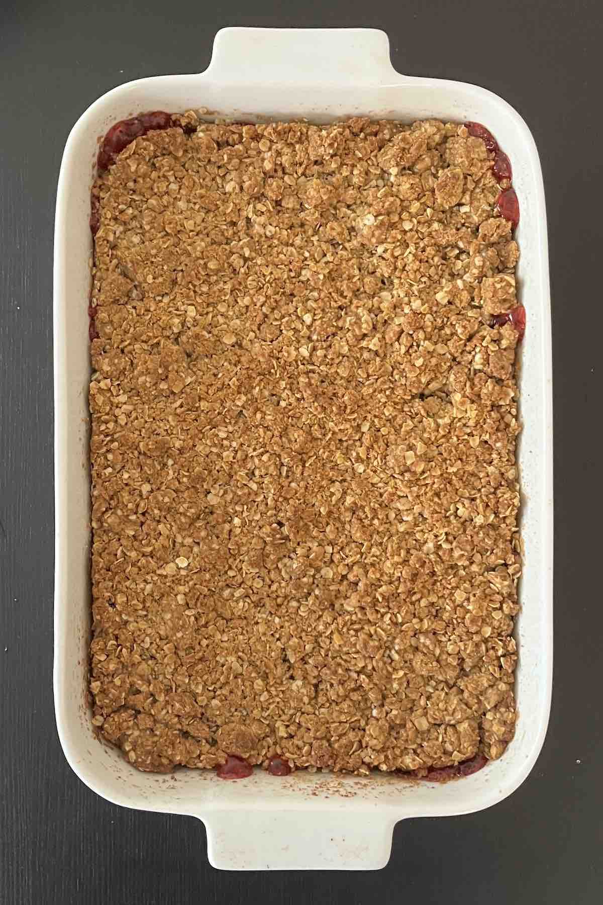 Baked cherry crisp in a baking dish.
