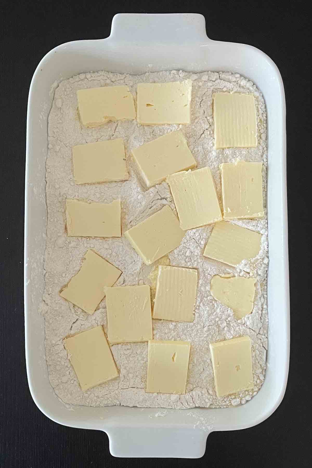 Slices of butter in a baking dish.