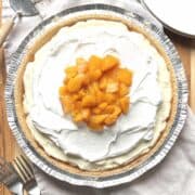 No bake peach cream pie on a wooden table.