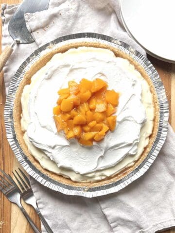 No bake peach cream pie on a wooden table.