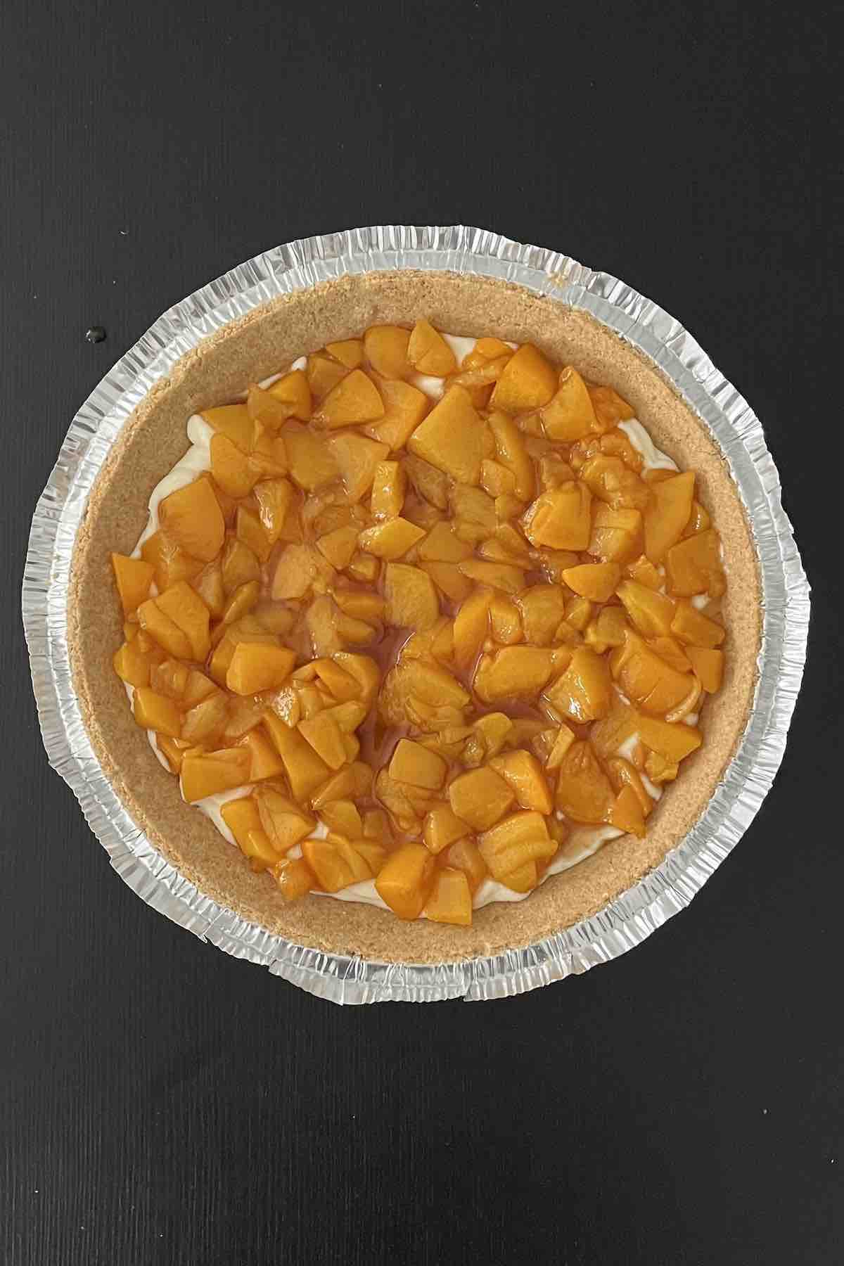 Layer of peaches in pie crust.