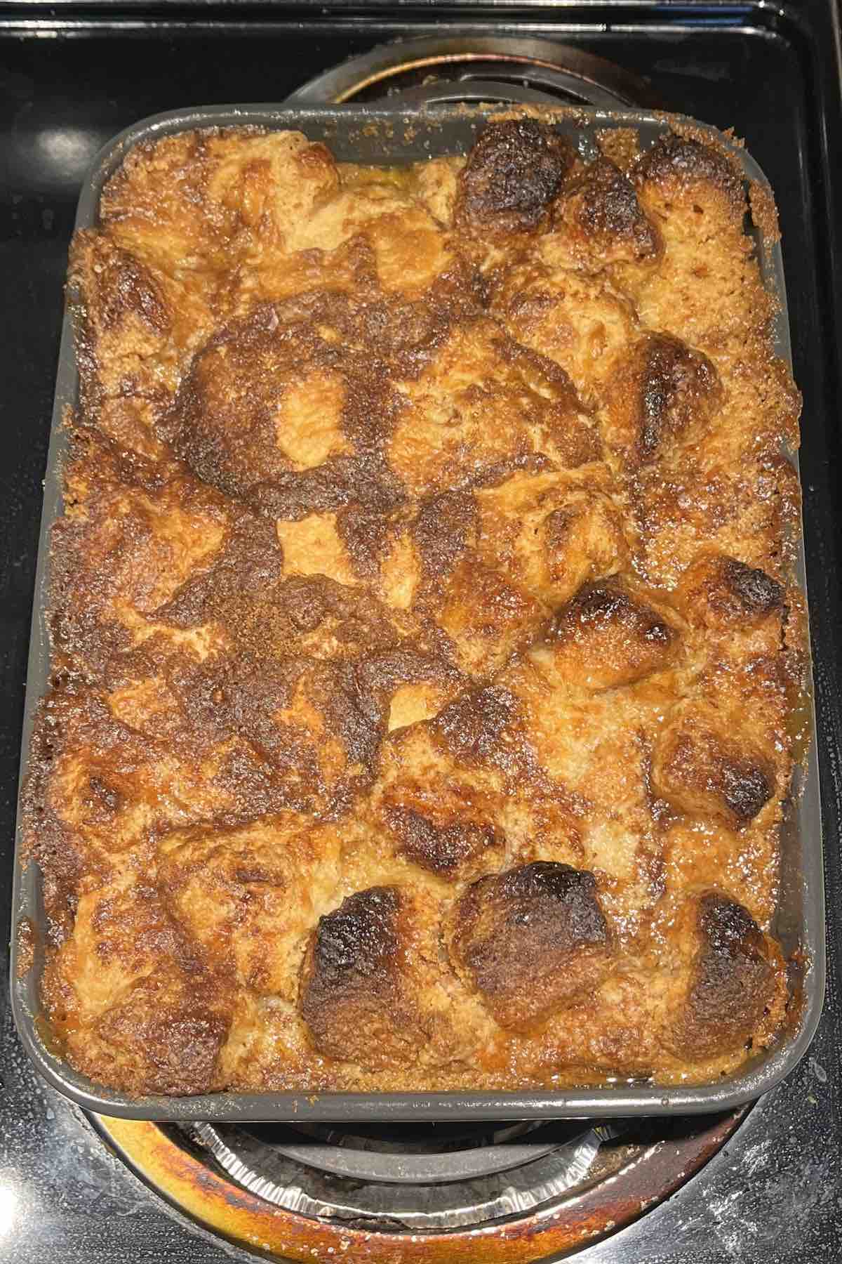 Baked cinnamon roll dump cake in a baking dish.