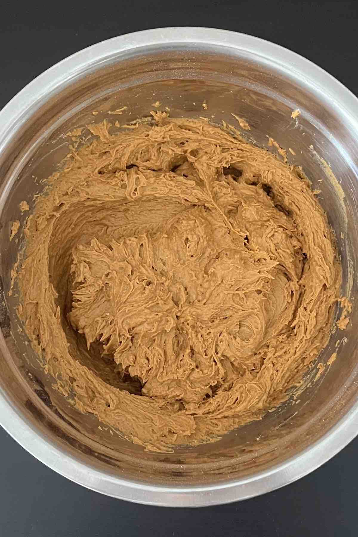 Cake mix and pumpkin puree mixed together in a bowl.
