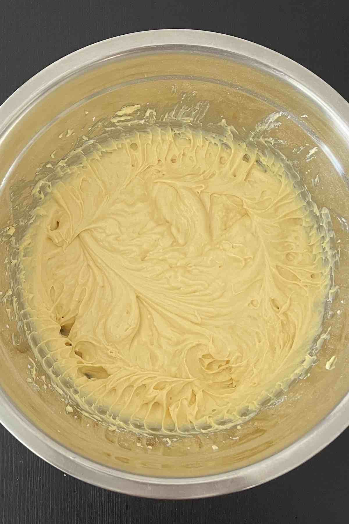 Cake mix, eggs and sour cream mixed together in a bowl.